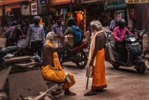 Two Indian gurus talking in a busy street